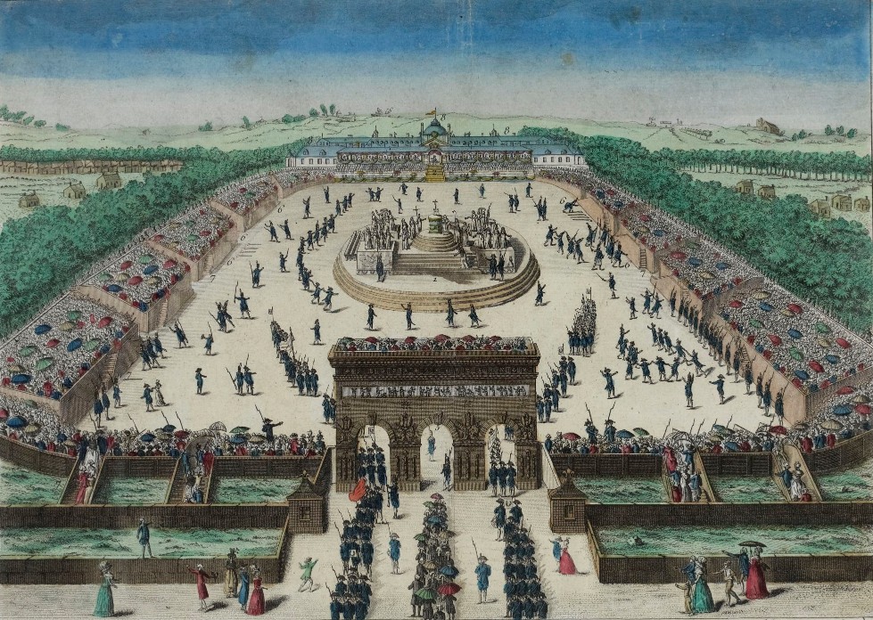 This is a detailed colored engraving that captures a National Festivity during the French Revolution era. The scene is a bird’s-eye view of an elaborate outdoor celebration, possibly in a large public square or garden. The festivities are depicted with precise organization, with rows of spectators on both sides, some under the shelter of striped tents and others exposed to the open air. The attendees are dressed in period clothing, with women in long dresses and men in coats and hats. In the center, there is a large circular formation of participants, surrounded by uniformed soldiers and a disciplined crowd. Multiple regiments are seen marching in formation towards an ornate, triumphal arch-style structure. The background shows a palace and rural landscapes, suggesting this event takes place in an expansive royal or public ground. The overall depiction is of a grand and orderly celebration, with a sense of joy and national pride.